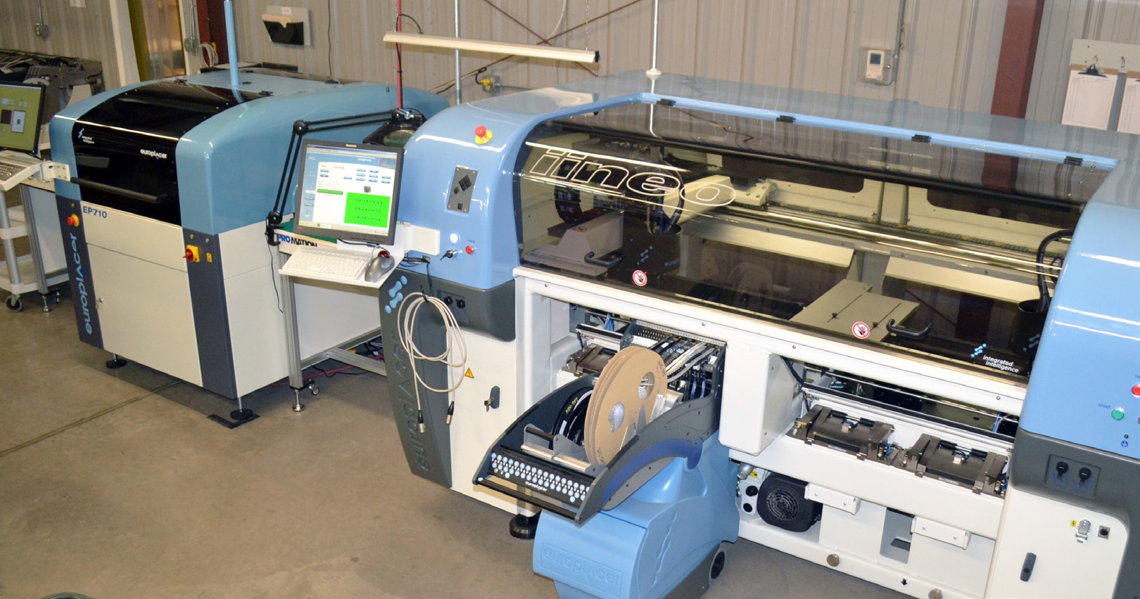 Populated boards moving through the SMT line on the production floor